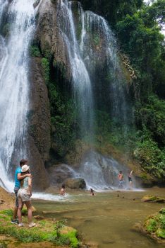 Couple and friends enjoying the pool of water by the Warterfall in Topes de Collantes, Cuba