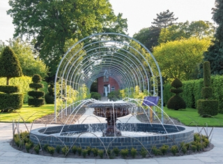 Fountain and topiary at Wisteria Walk, RHS Garden Wisley nr Woking, Surrey © RHS, Joanna Kossak