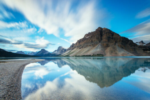 Mountains reflecting in Bow Lake along the Icefields Parkway