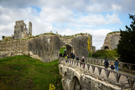 People walking towards Corfe Castle's Outer Gatehouse