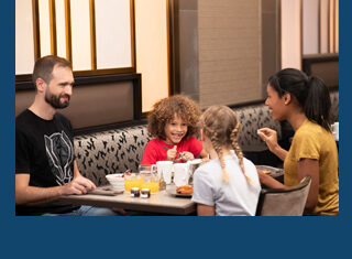 Guests at Empire State Club Lounge, Disney Hotel New York - The Art of Marvel