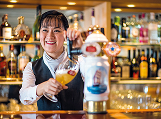 Joy serving at the bar in Portsmouth