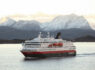 Ship sailing pass snowy mountains