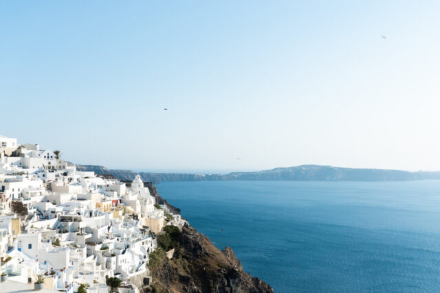 Santorini, the Cyclades, Greece - Aerial view of Oia, Mountains, Buildings, Ocean