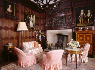 Sizergh Castle, Cheshire - The Queen's Room at Sizergh Castle showing oak panelling, stone Tudor fireplace, carved oak overmantel & armchair
