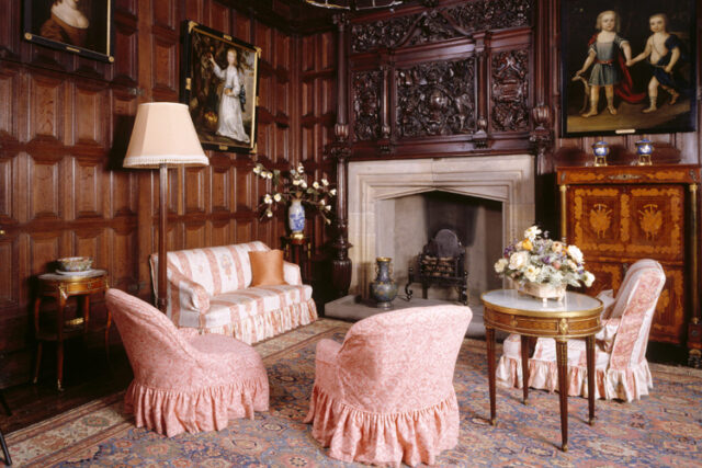 The Queen's Room at Sizergh Castle showing oak panelling, stone Tudor fireplace, carved oak overmantel & armchair