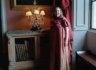 Lady Claire in costume in the Long Gallery at Castle Howard