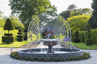 Fountain and topiary at Wisteria Walk at RHS Garden Wisley