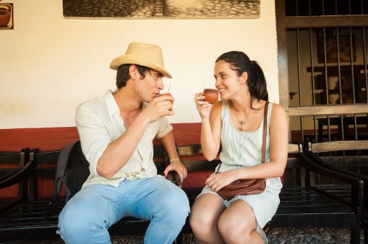 A couple enjoying cocktails in La Canchanchara bar in Trinidad