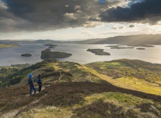 Loch Lomond & Trossachs National Park, Scotland - Walkers taking in the view of Loch Lomond from Conic Hill part of the West Highland Way © VisitScotland, Kenny Lam EXPIRES 3.12.2021