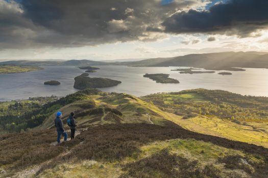Loch Lomond & Trossachs National Park, Scotland - Walkers taking in the view of Loch Lomond from Conic Hill part of the West Highland Way © VisitScotland, Kenny Lam EXPIRES 3.12.2021