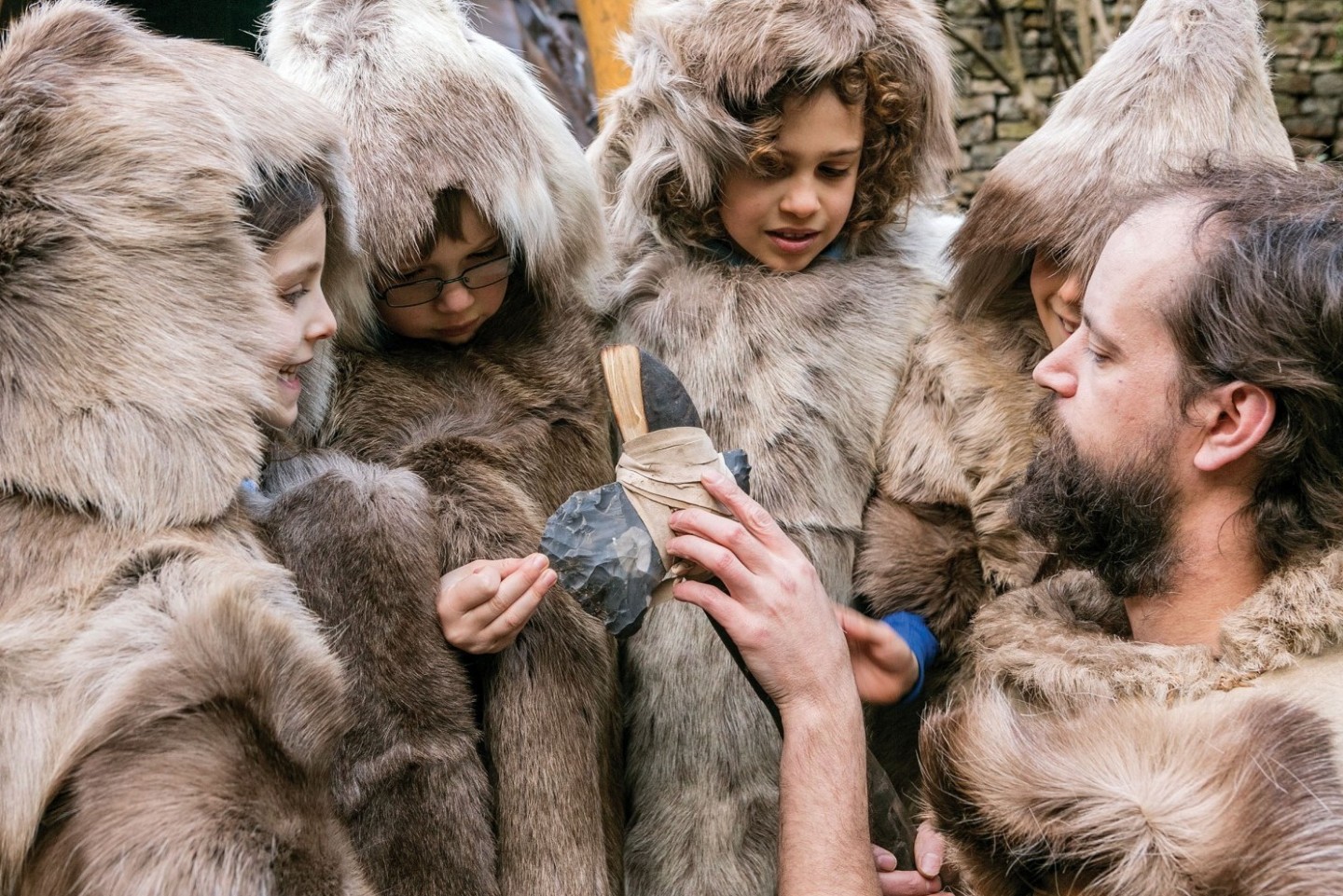 Children dressed as hunters in animal skins at Cheddar Gorge Museum