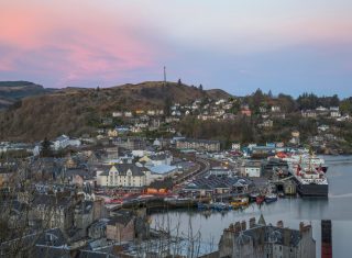Oban, Scotland - Oban Harbour and Pulpit Hill from McCaigs Tower at dawn © VisitScotland, Kenny Lam EXPIRES 30.1.2022