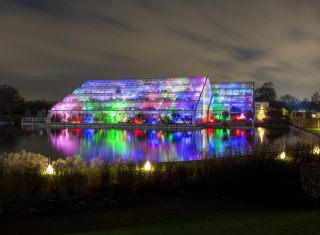 RHS Garden Wisley, nr Woking, Surrey - Christmas Glow 2017-Glasshouse with liights © RHS, Paul Debois